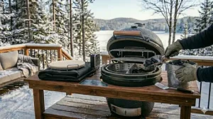 Stainless steel charcoal basket with a divider for zoned heating and efficient fuel use in a kamado cooker.