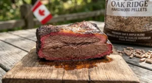 Moist slice of beef brisket on a weathered oak board showcasing a deep pink smoke ring achieved with clean-burning hardwood pellets.