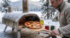 Using a portable pizza oven for winter camping on a snowy afternoon in Quebec.