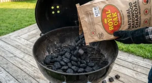 Natural hardwood charcoal briquettes under $30 CAD poured into an outdoor kettle grill.
