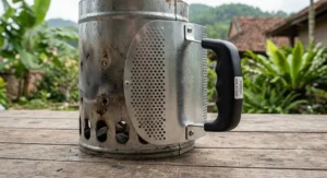 Close up of a charcoal chimney starter under 40 CAD showing the heat shield safety handle for comfortable grip.