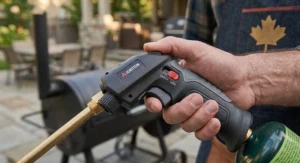 Detailed view of an ergonomic propane torch lighter for grilling showcasing the safety lock mechanism and durable ignition switch.